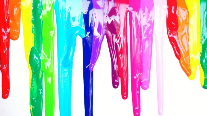rainbow colors of paint running down a canvas
