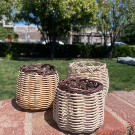 3 baskets on brick in front of grassy lawn